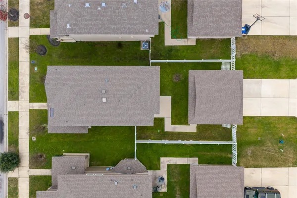 an aerial view of a house with a garden and a yard