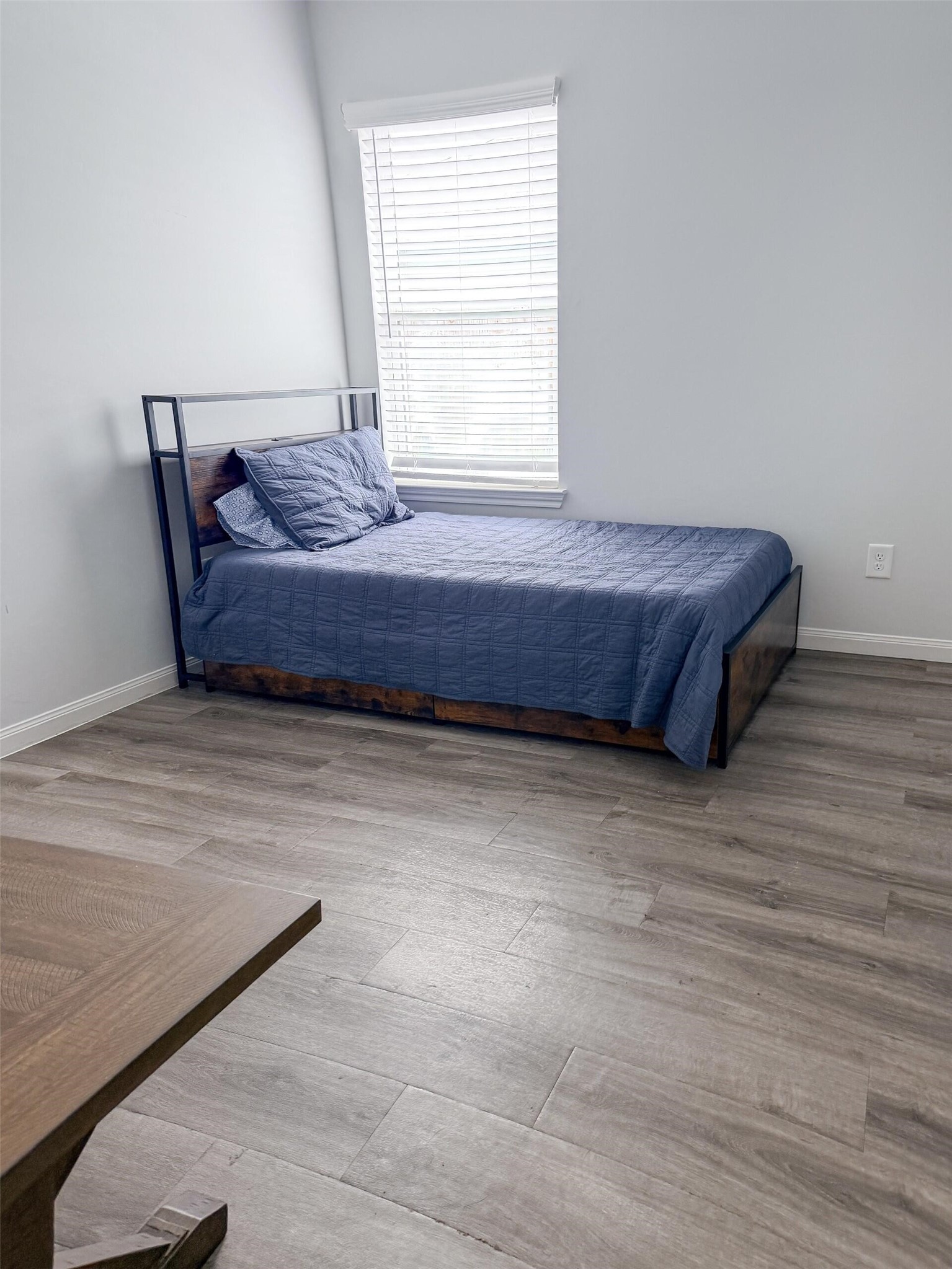 1513 22nd Street Hempstead, TX 77445 - Photo 7 of 12 a bedroom with a bed and window