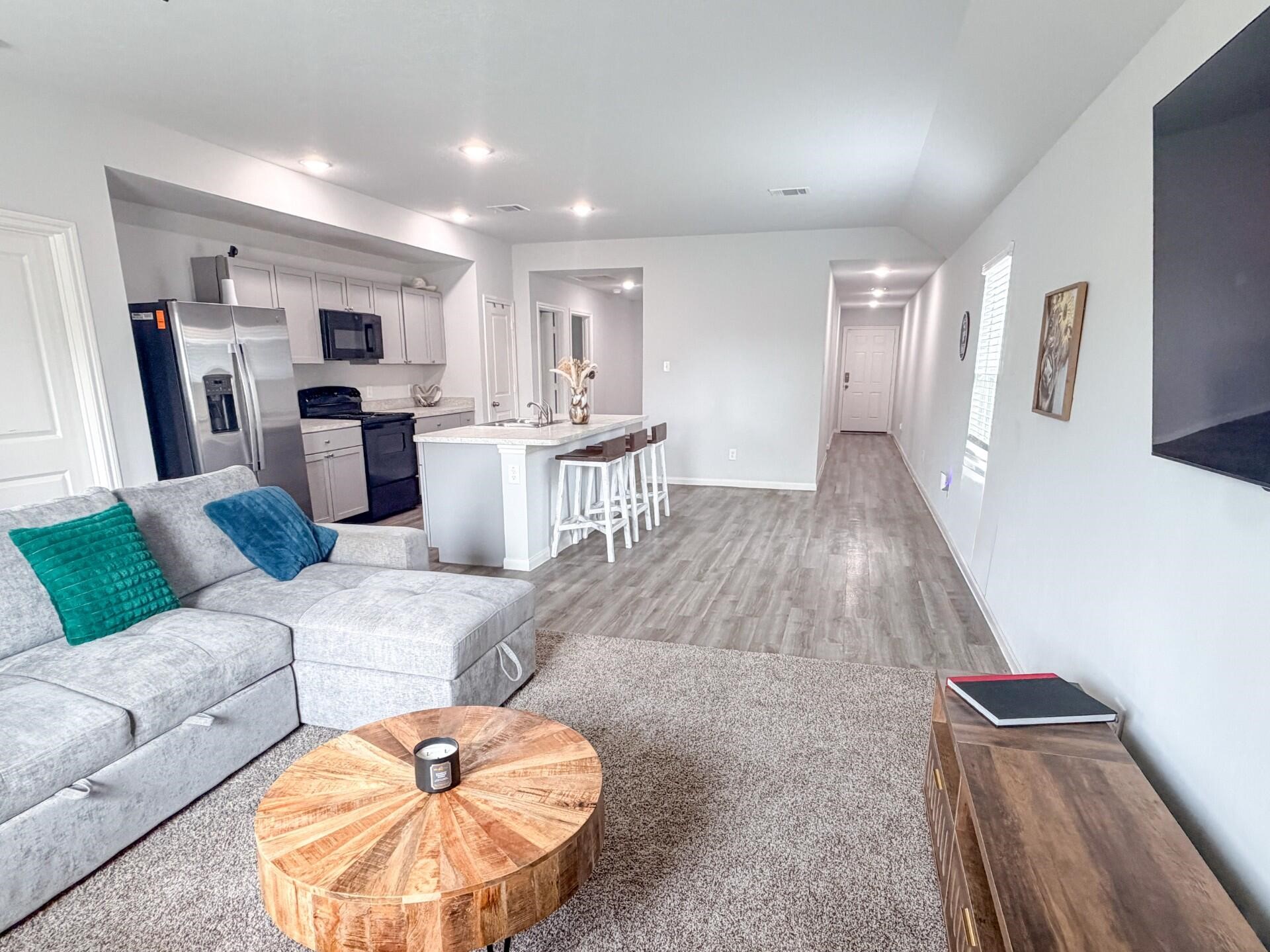 1513 22nd Street Hempstead, TX 77445 - Photo 9 of 12 a living room with furniture and a wooden floor