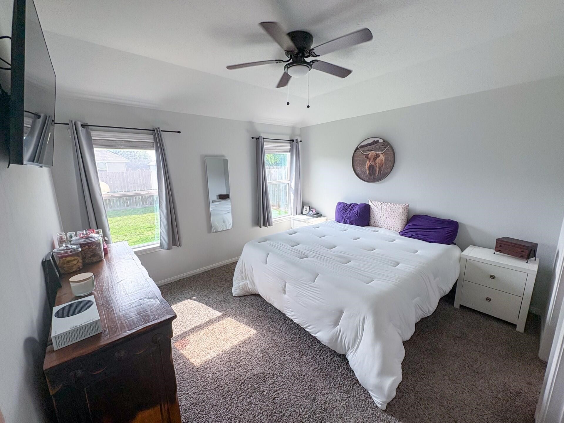 1513 22nd Street Hempstead, TX 77445 - Photo 10 of 12 a bedroom with a bed and a chandelier
