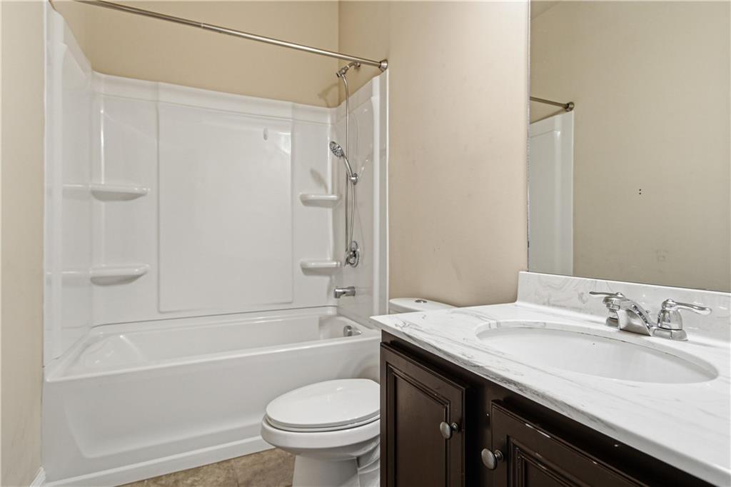 114 Madison Street Canton, GA 30115 - Photo 33 of 39 a bathroom with a granite countertop sink toilet and shower