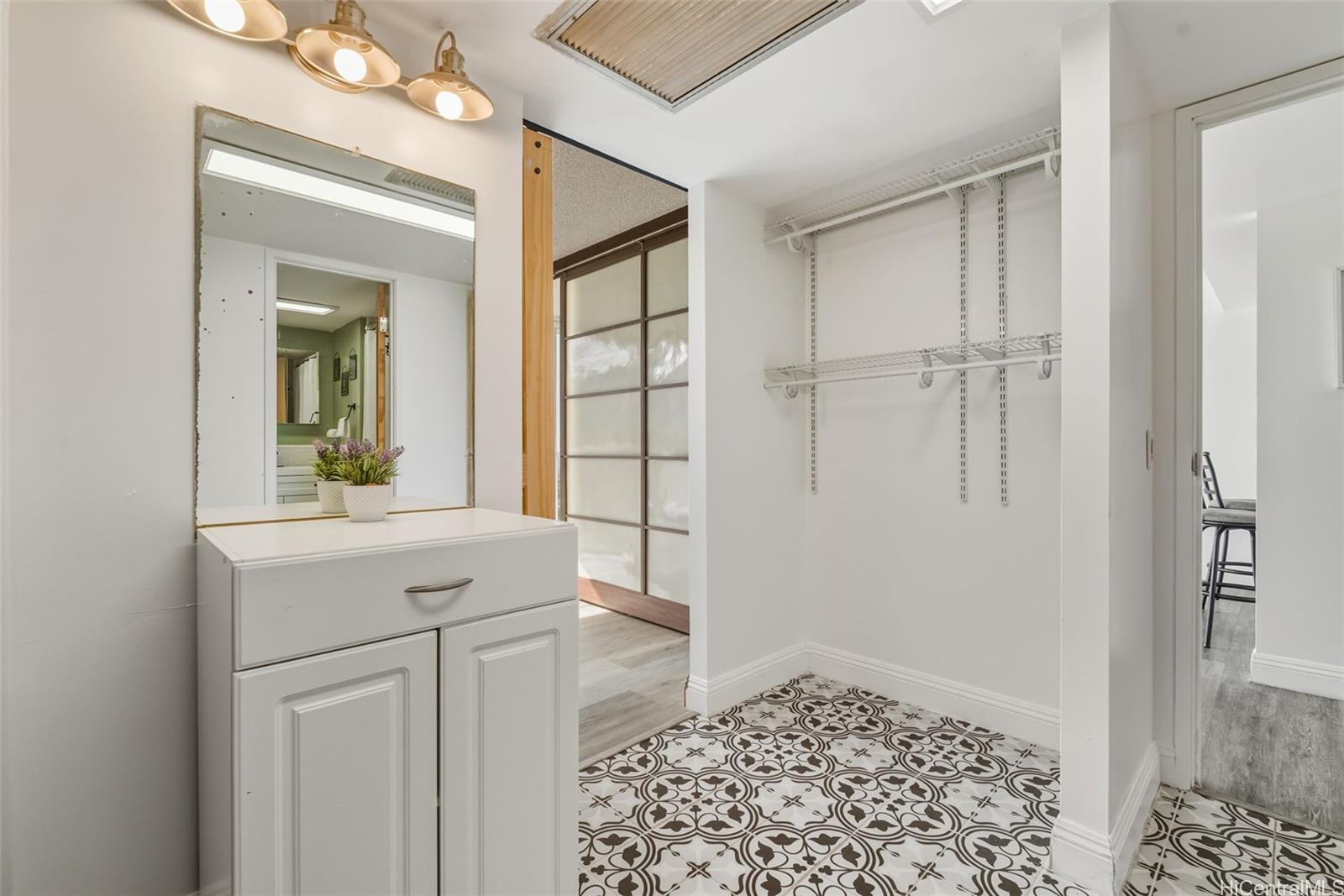 84-770 Kili Drive, Unit 434 Waianae, HI 96792 - Photo 8 of 13 a bathroom with a sink a mirror and shower