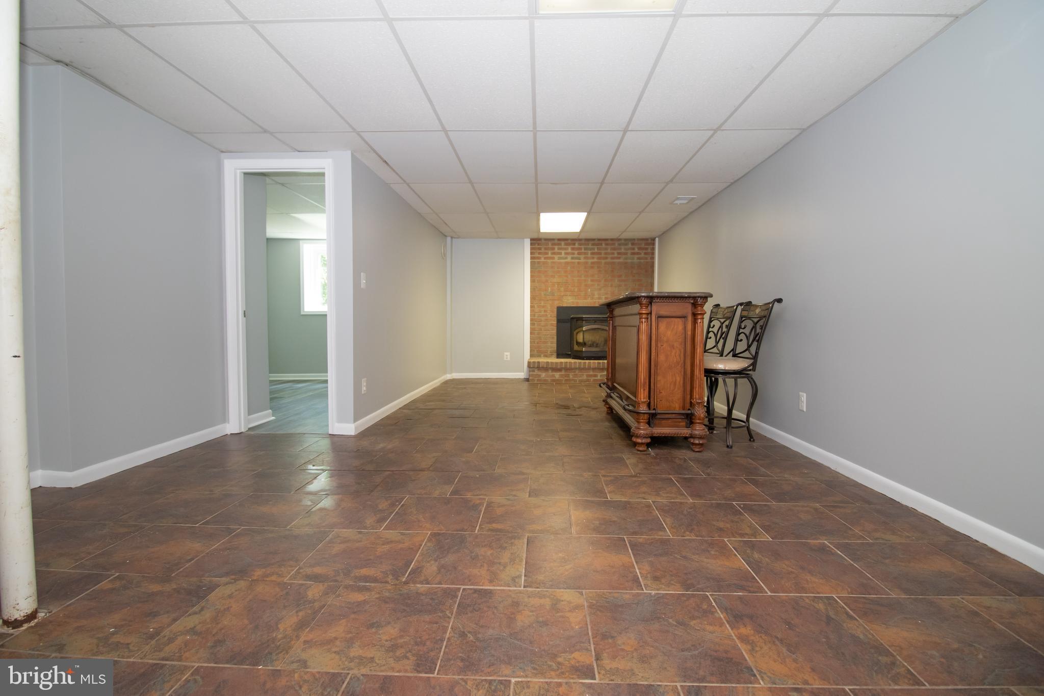 5741 Stephen Reid Road Huntingtown, MD 20639 - Photo 8 of 46 Rec room with wood stove