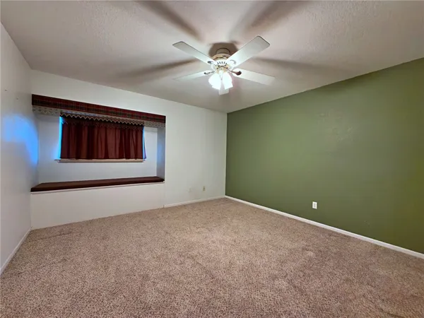 a bedroom with bed and a chandelier