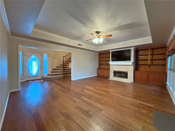 wooden floor fireplace and natural light in empty room
