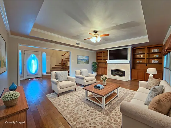 a living room with furniture a fireplace and a flat screen tv