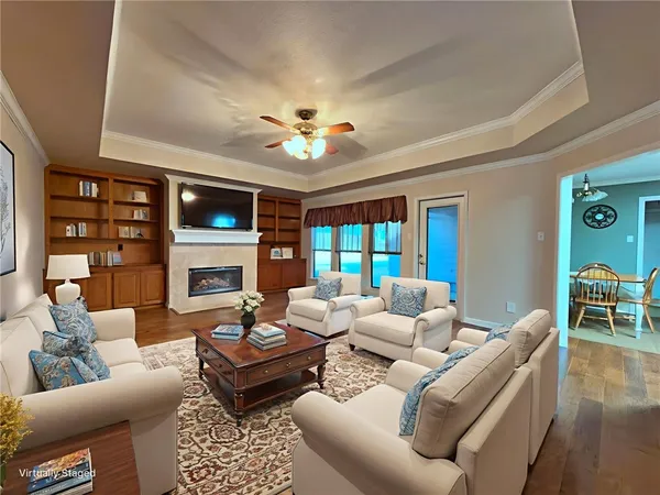 a living room with furniture a fireplace and a table