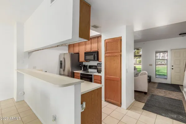 a kitchen with a refrigerator and microwave