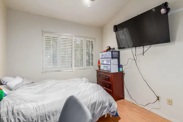 a bedroom with a bed and a flat screen tv