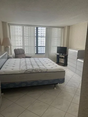 a living room with a bed furniture and a window