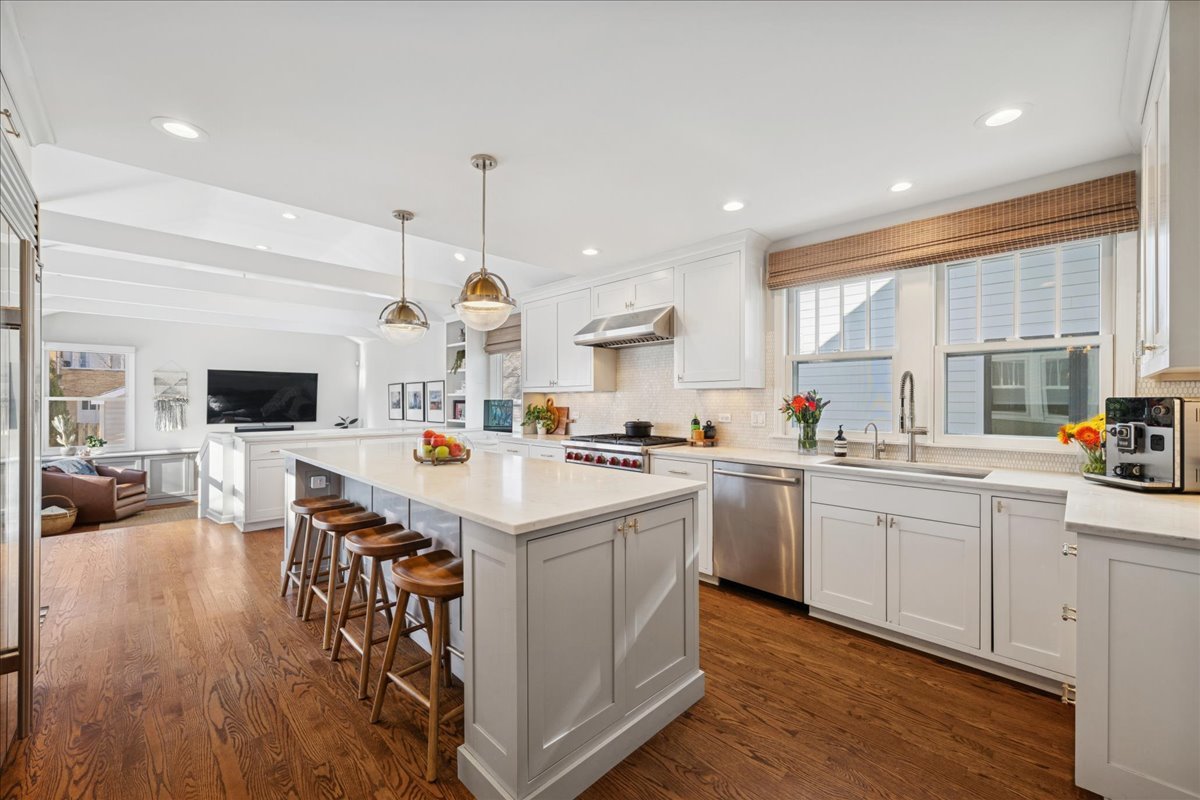2740 Asbury Avenue Evanston, IL 60201 - Photo 11 of 40 a kitchen with a sink a stove and chairs