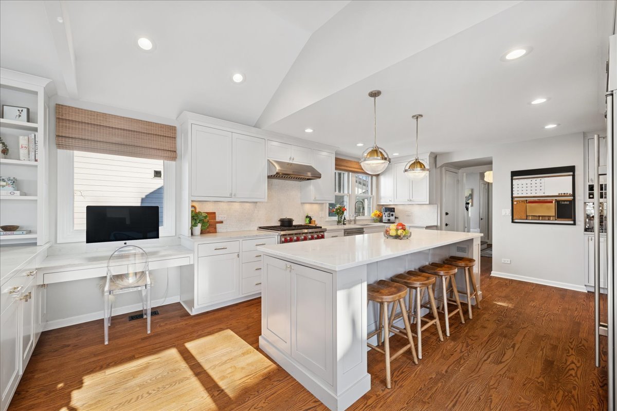 2740 Asbury Avenue Evanston, IL 60201 - Photo 13 of 40 a kitchen with a dining table chairs and white cabinets