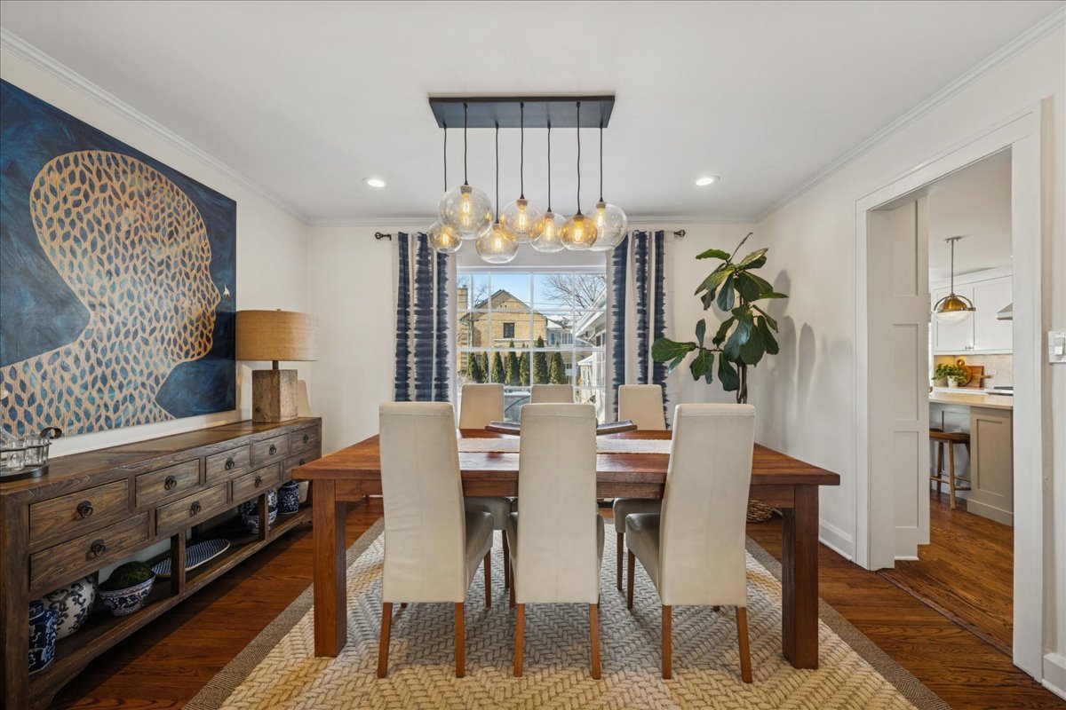 2740 Asbury Avenue Evanston, IL 60201 - Photo 9 of 40 a view of a dining room with furniture a rug and wooden floor