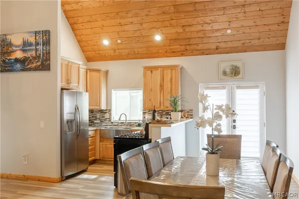 a dining room with furniture a rug and wooden floor