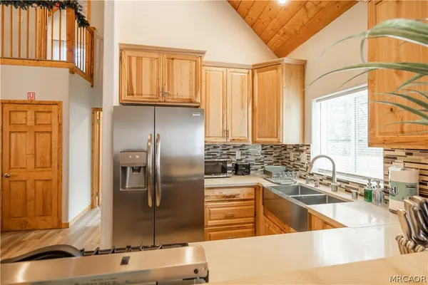 a kitchen with stainless steel appliances granite countertop a sink and a stove