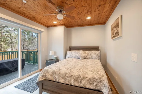 a large bed sitting in a bedroom next to a window