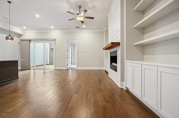 a view of an empty room with a fireplace and a window