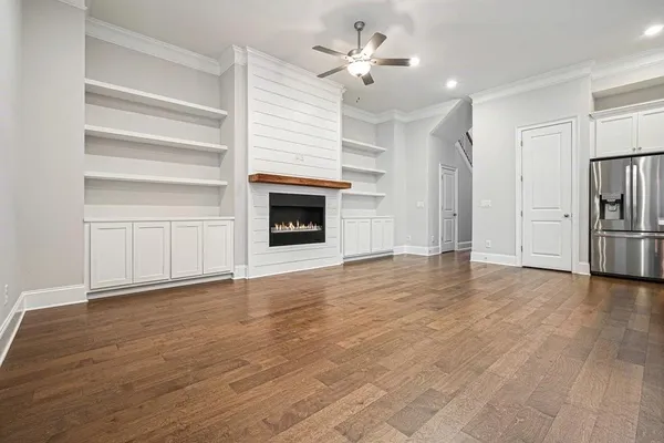 a kitchen with stainless steel appliances granite countertop a refrigerator a sink and a stove