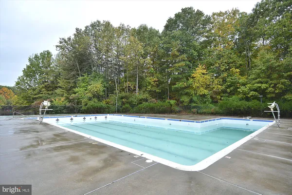 a view of a house with swimming pool and sitting area