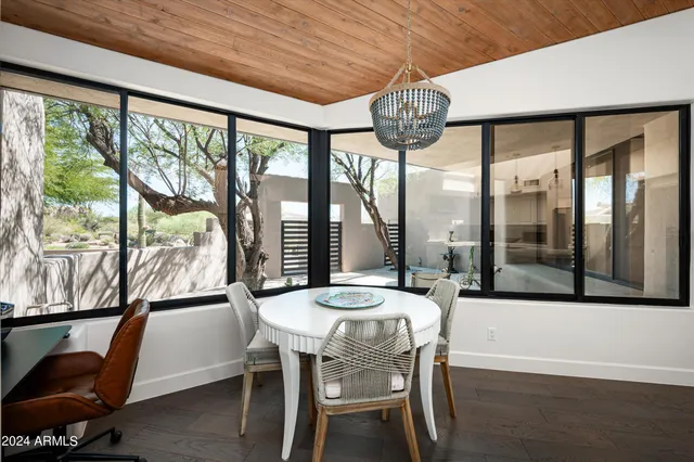 a view of a dining room with furniture wooden floor and chandelier