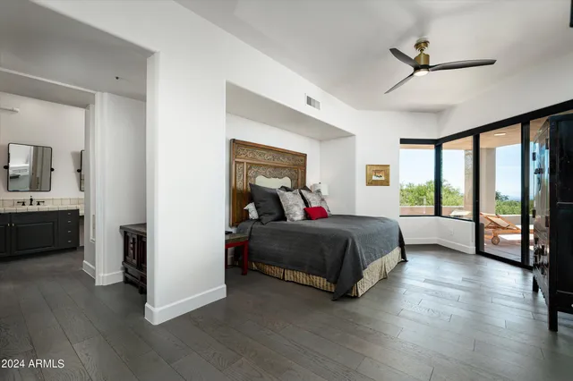 a living room with a bed furniture and a large window