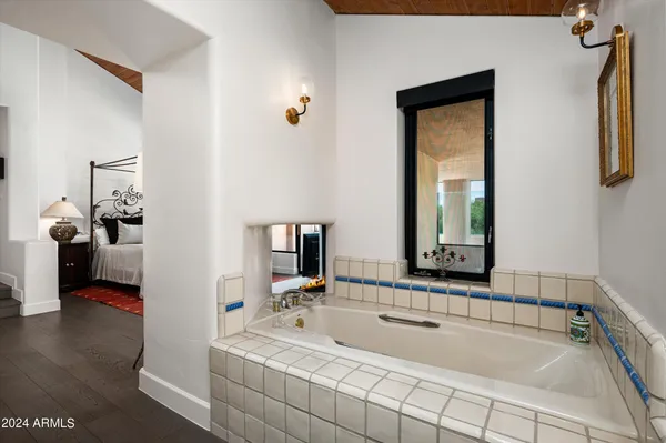 a spacious bathroom with sink and mirror