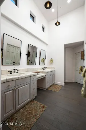 a spacious bathroom with a double vanity sink and mirror