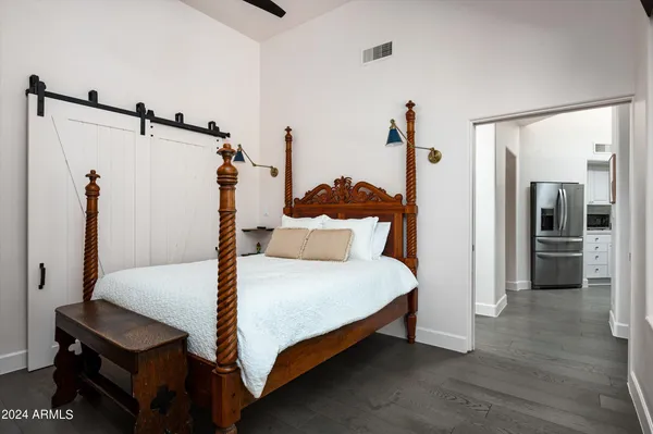 a bedroom with a bed and a mirror