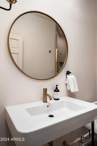 a bathroom with a sink and mirror