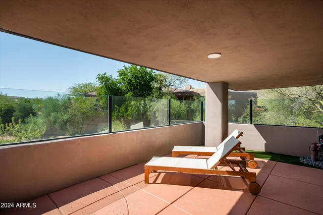 a view of balcony with couch and wooden fence