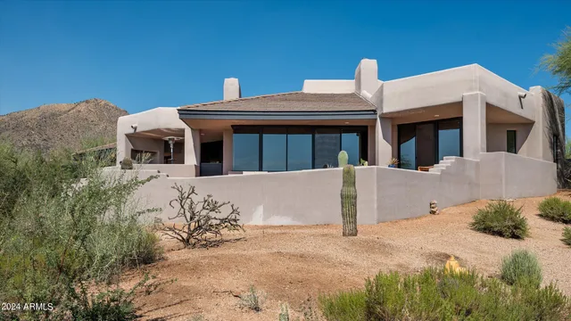 a view of a white house with large windows