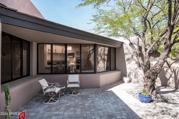 a living room filled with furniture and a potted plant