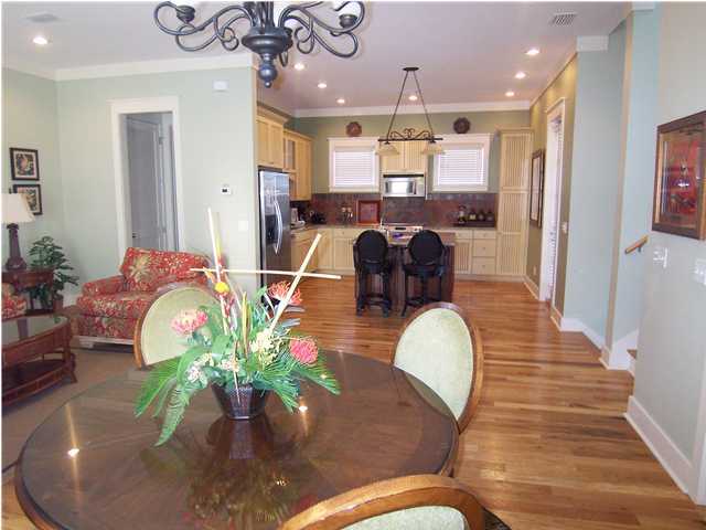 10140 Co Hwy Inlet Beach, Unit 33 30A Inlet Beach, FL 32461 - Photo 5 of 13 a dining room filled chandelier and wooden floor