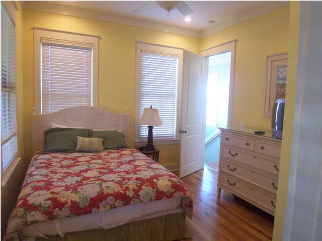 10140 Co Hwy Inlet Beach, Unit 33 30A Inlet Beach, FL 32461 - Photo 7 of 13 a bedroom with a bed and wooden floor