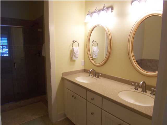 10140 Co Hwy Inlet Beach, Unit 33 30A Inlet Beach, FL 32461 - Photo 8 of 13 a bathroom with a granite countertop double vanity sinks and a mirror