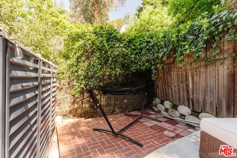 a view of a backyard with sitting area