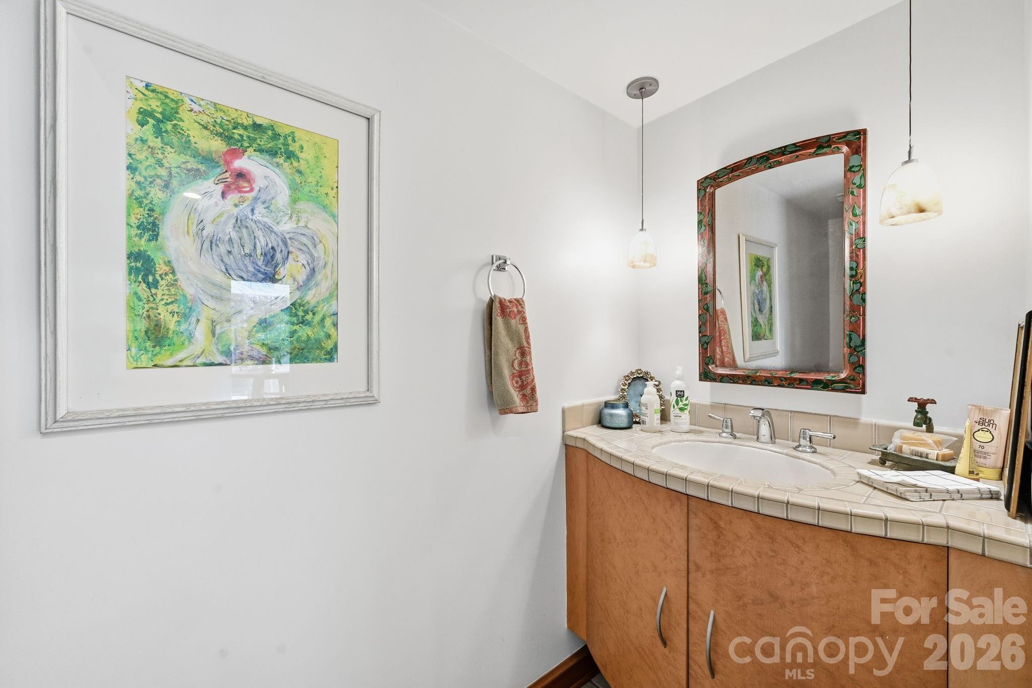 1916 Davis Road Davidson, NC 28036 - Photo 15 of 45 a bathroom with a granite countertop sink a large mirror and a window