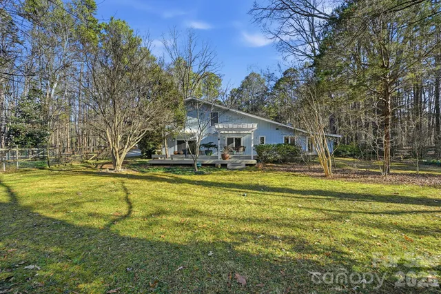 a view of swimming pool with outdoor seating and yard