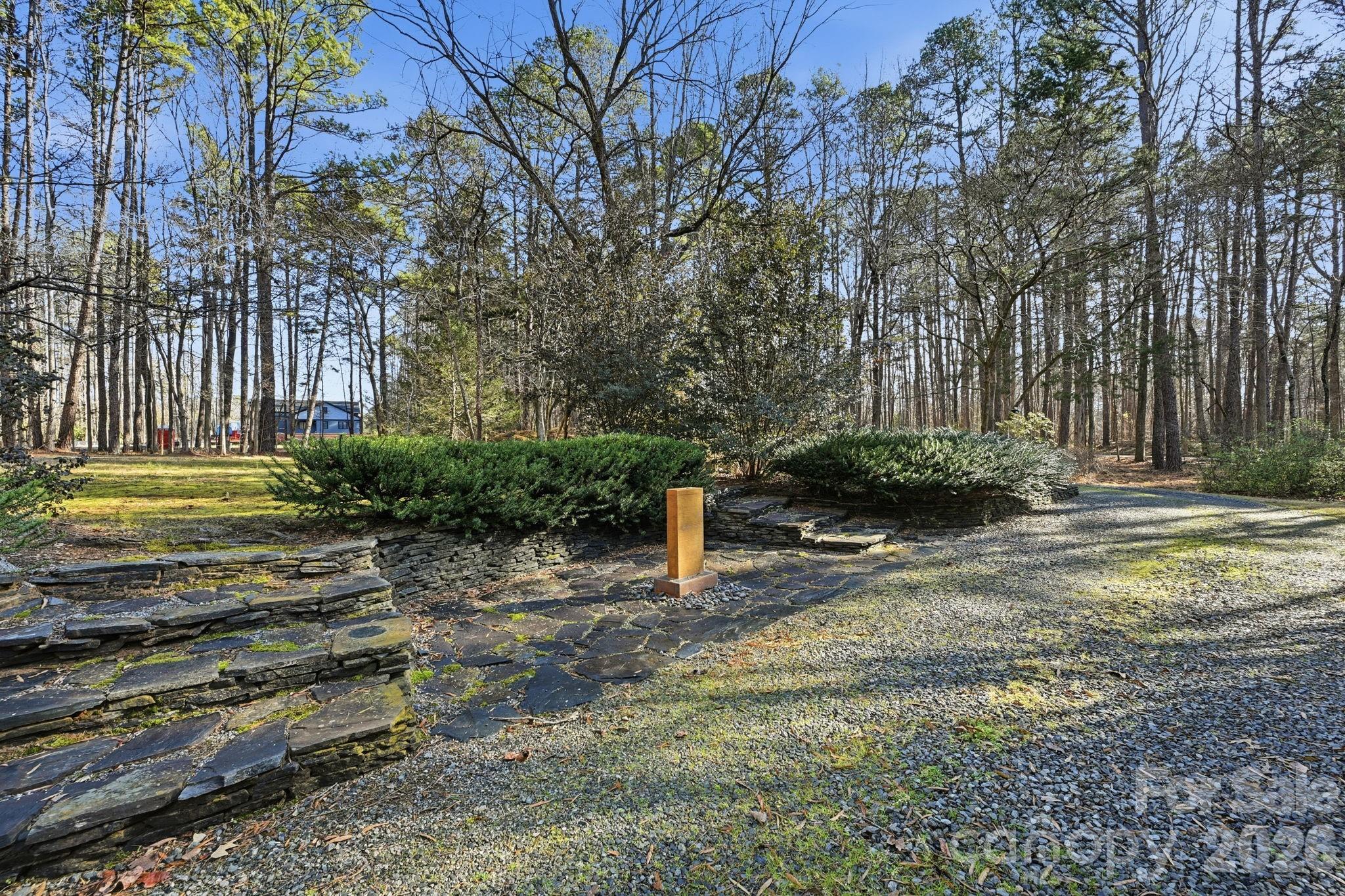 1916 Davis Road Davidson, NC 28036 - Photo 4 of 45 a backyard of a house with lots of green space