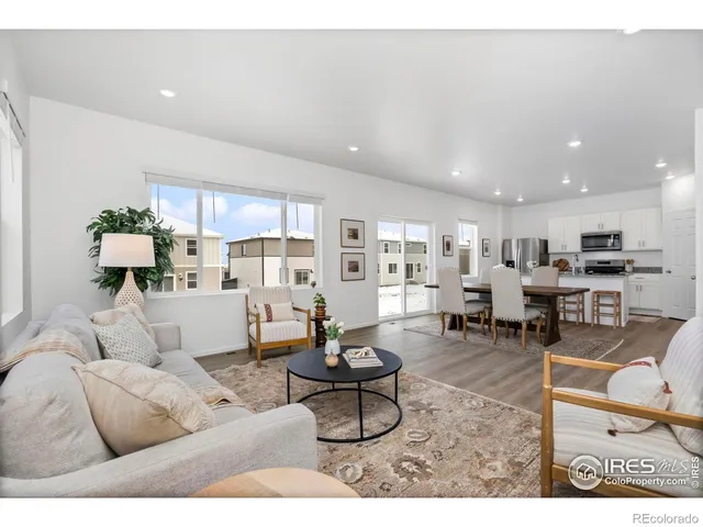 a living room with furniture and view of kitchen