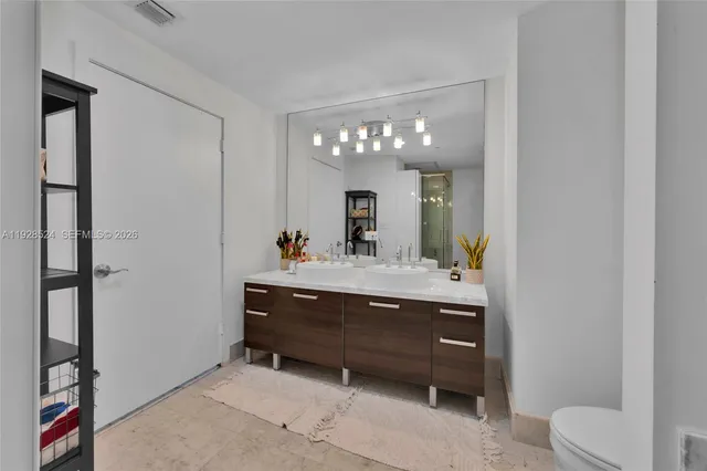 a bathroom with a sink vanity and a mirror