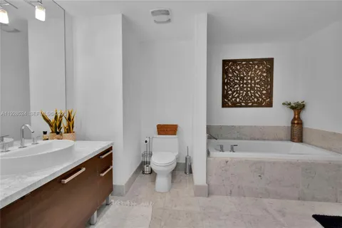 a bathroom with a sink a toilet and mirror