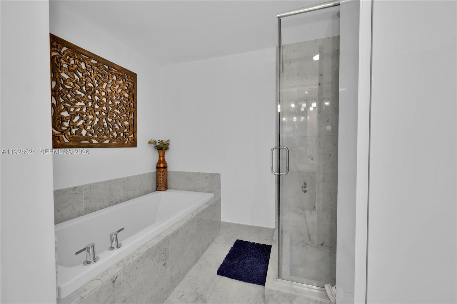 253 Northeast 2nd Street, Unit 1710 Miami, FL 33132 - Photo 15 of 22 a bathroom with a tub shower and sink