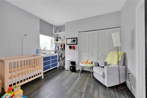 a bedroom with furniture and a baby crib