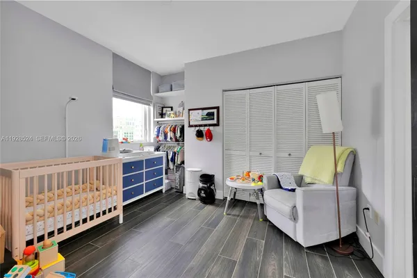 a bedroom with furniture and a baby crib
