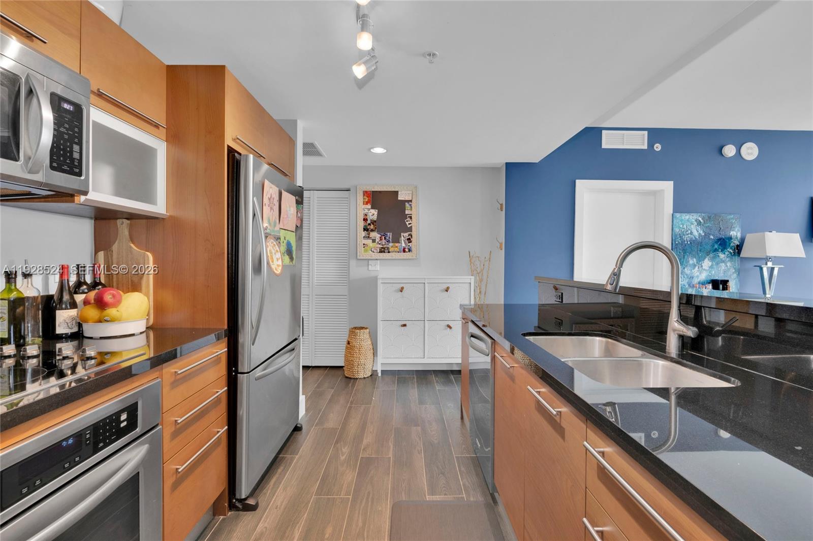 253 Northeast 2nd Street, Unit 1710 Miami, FL 33132 - Photo 10 of 22 a kitchen with stainless steel appliances granite countertop a sink stove and refrigerator