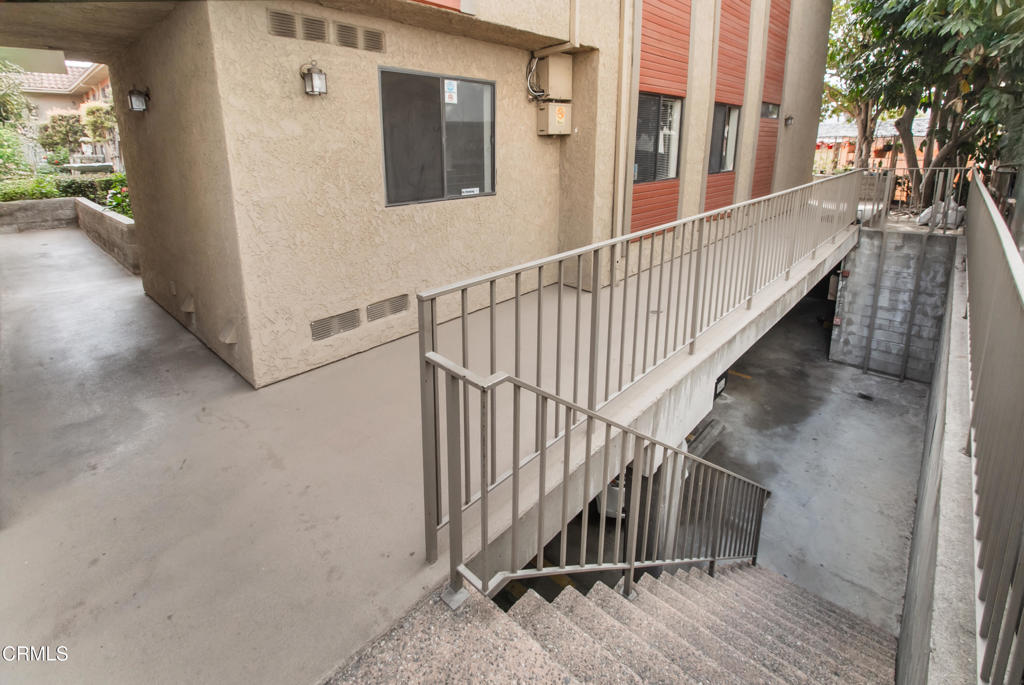 1169 Rosedale Avenue, Unit 204 Glendale, CA 91201 - Photo 21 of 27 a view of staircase with lots of frames on wall and a view of a house