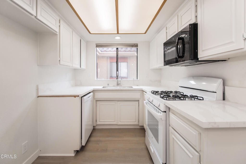 1169 Rosedale Avenue, Unit 204 Glendale, CA 91201 - Photo 7 of 27 a kitchen with cabinets appliances a sink and a window