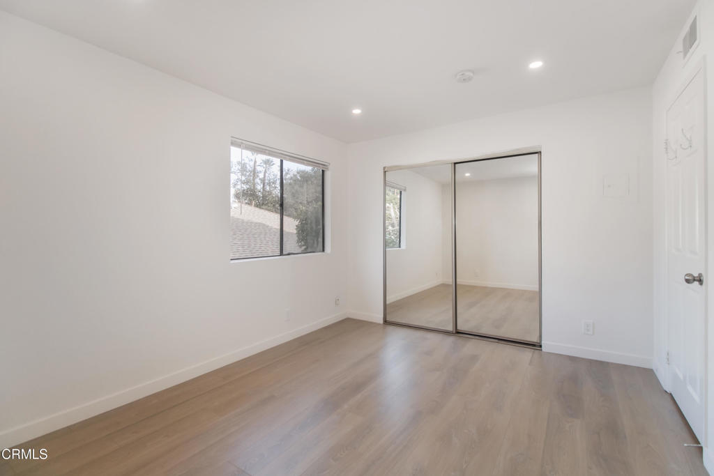 1169 Rosedale Avenue, Unit 204 Glendale, CA 91201 - Photo 10 of 27 an empty room with wooden floor and windows