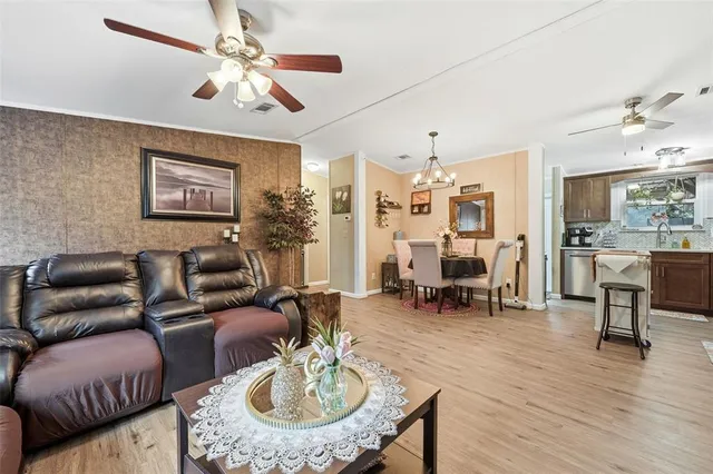 a living room with furniture kitchen view and a dining table